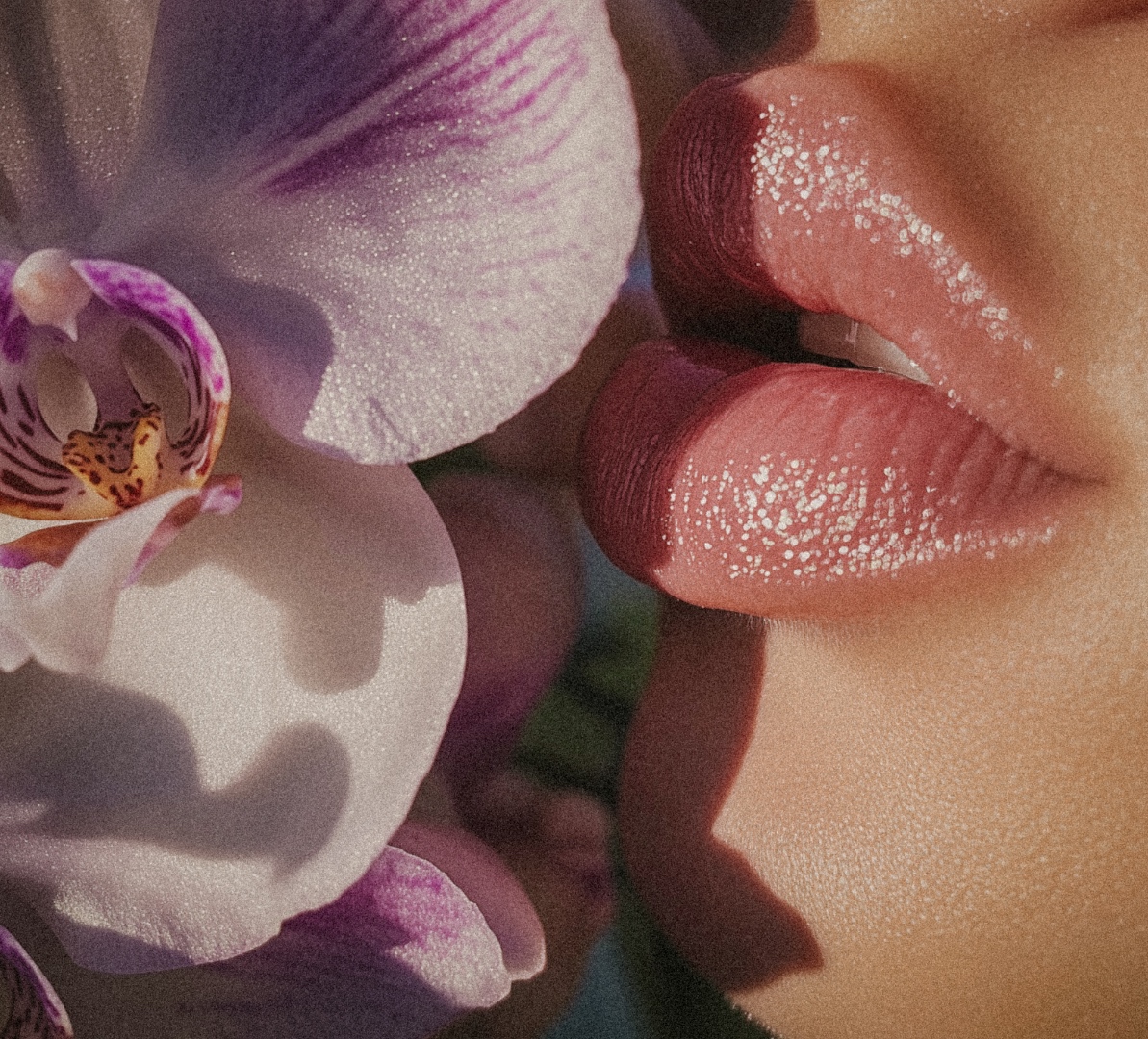 Woman surrounded by pink peonies and botanical florals — editorial beauty photography